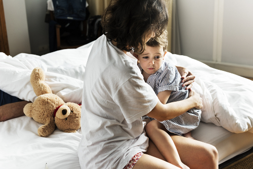 Mother comforting child awakened by a nightmare