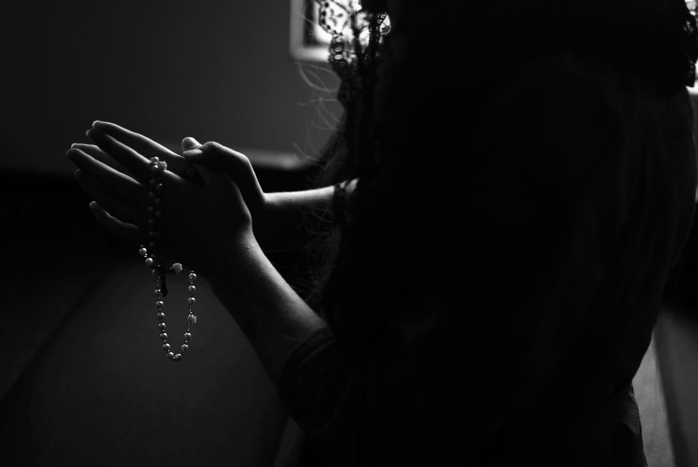 a religious woman holding a rosary