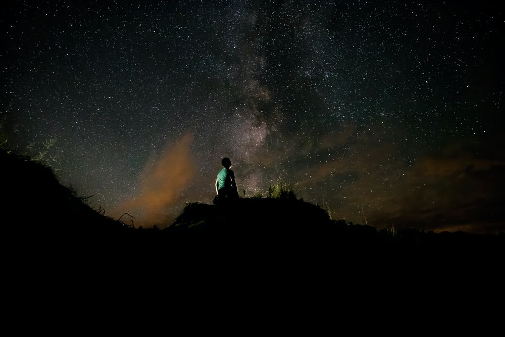 a man stares speculatively at the stars