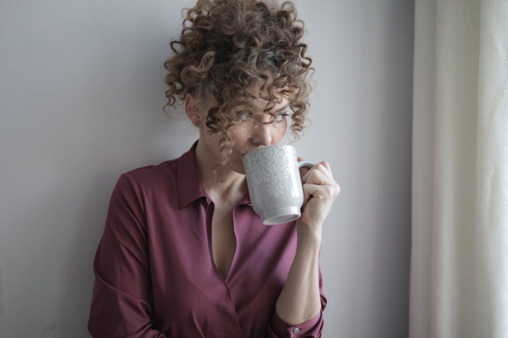 a woman drinking a hot beverage as she muses about 2021