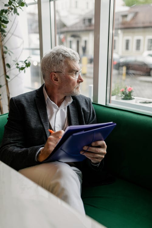 a man reading a channeling transcript for more insight into karmic influences