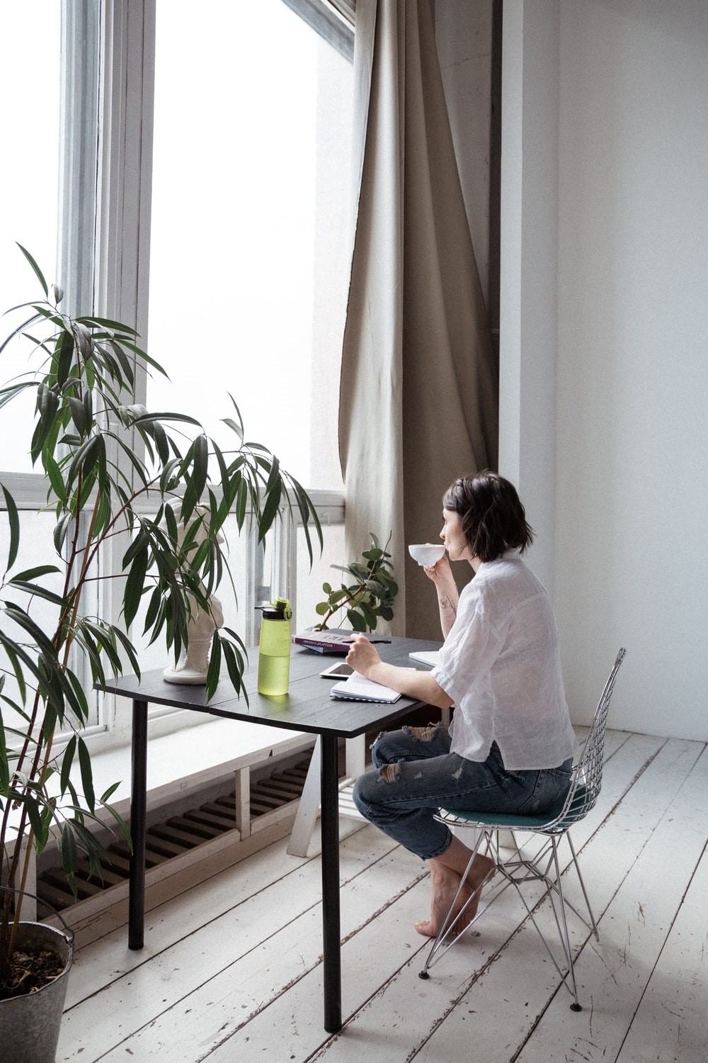 a woman sipping tea in her home office